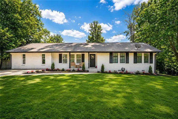 a front view of a house with a garden