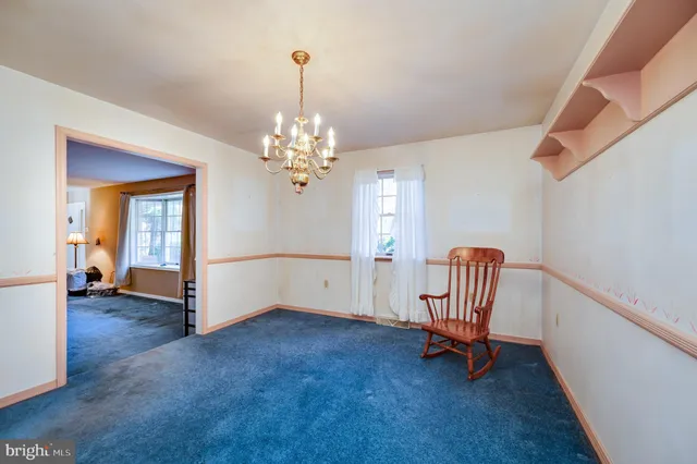a view of a room with stairs and a chandelier