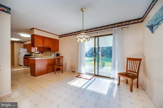 a open kitchen with stainless steel appliances granite countertop a stove top oven a sink and a refrigerator