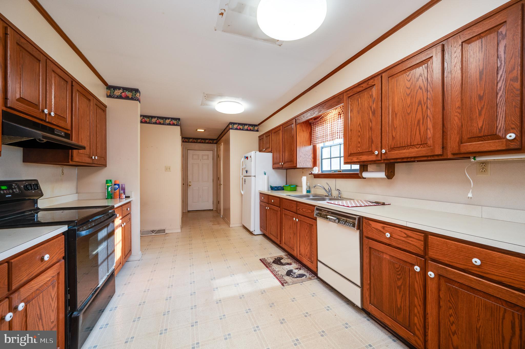 730 Texter Mountain Road Robesonia, PA 19551 - Photo 16 of 58 a kitchen with stainless steel appliances granite countertop wooden cabinets a sink and dishwasher a stove top oven with wooden floor