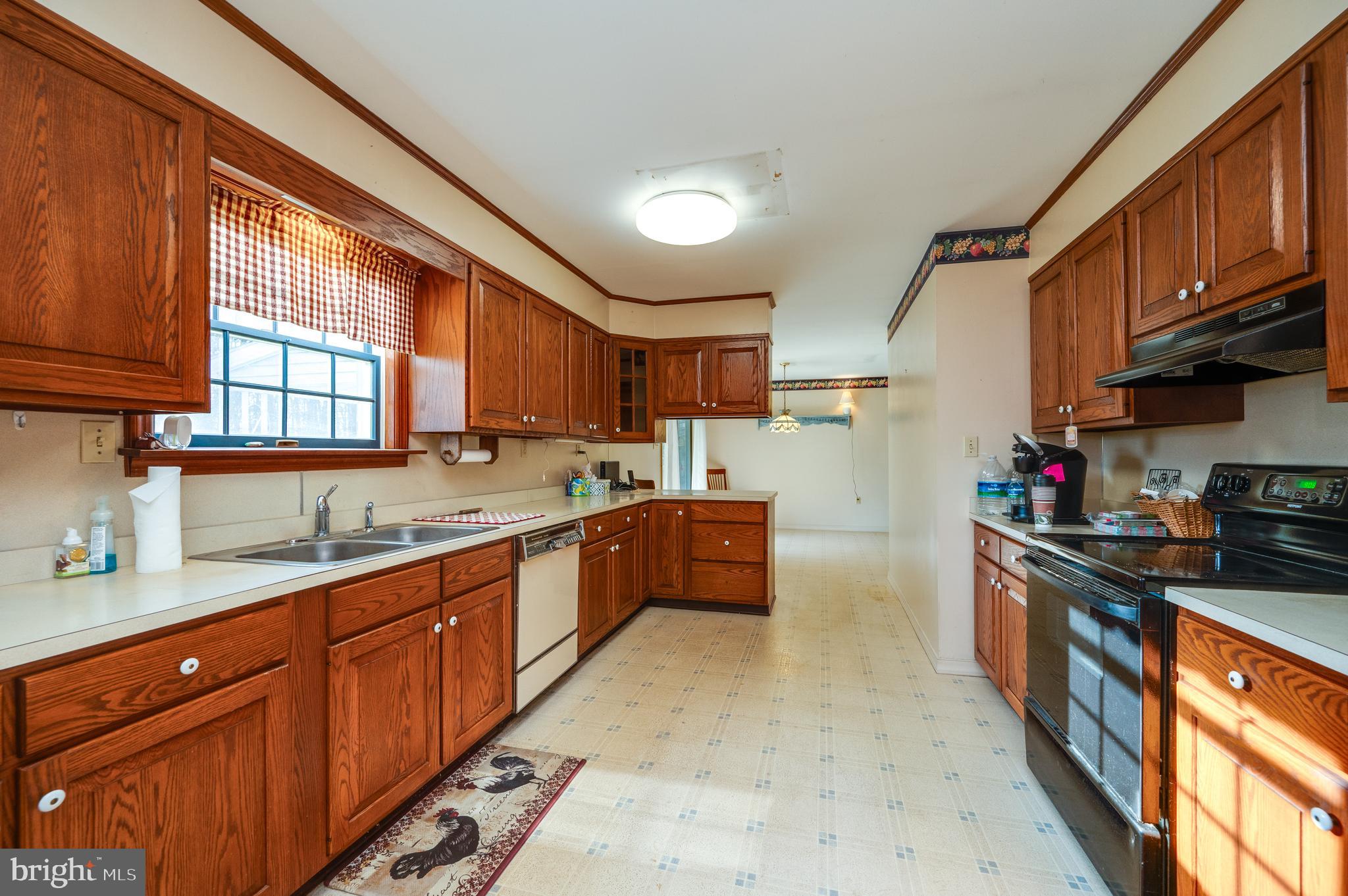 730 Texter Mountain Road Robesonia, PA 19551 - Photo 18 of 58 a kitchen with stainless steel appliances granite countertop wooden cabinets a sink dishwasher a stove and a refrigerator with wooden cabinets