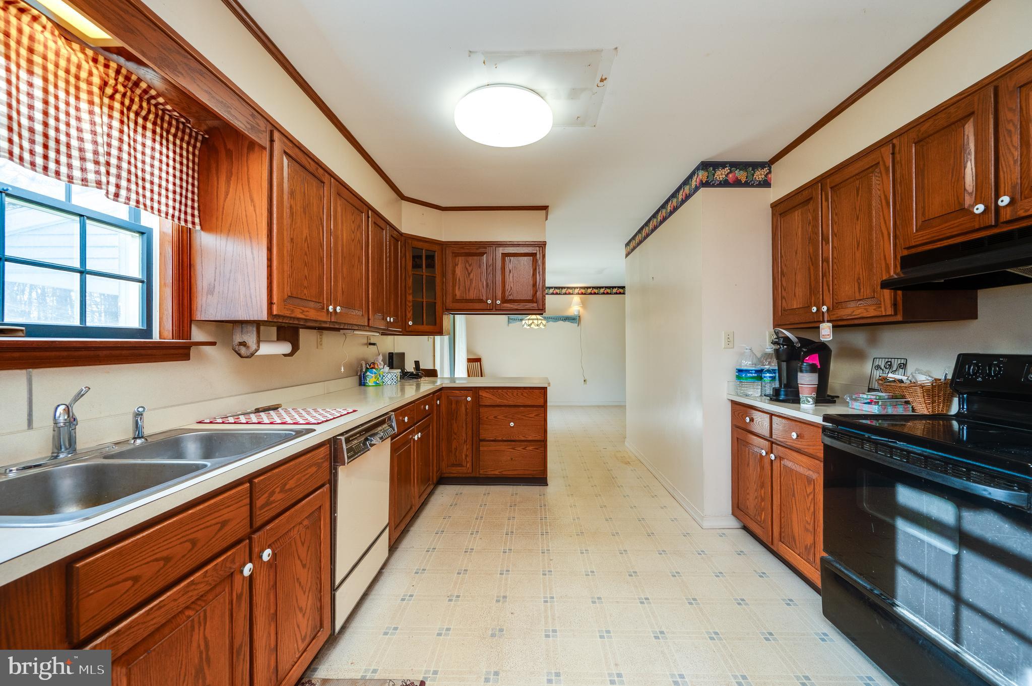 730 Texter Mountain Road Robesonia, PA 19551 - Photo 19 of 58 a kitchen with stainless steel appliances granite countertop a sink stove cabinets and a refrigerator