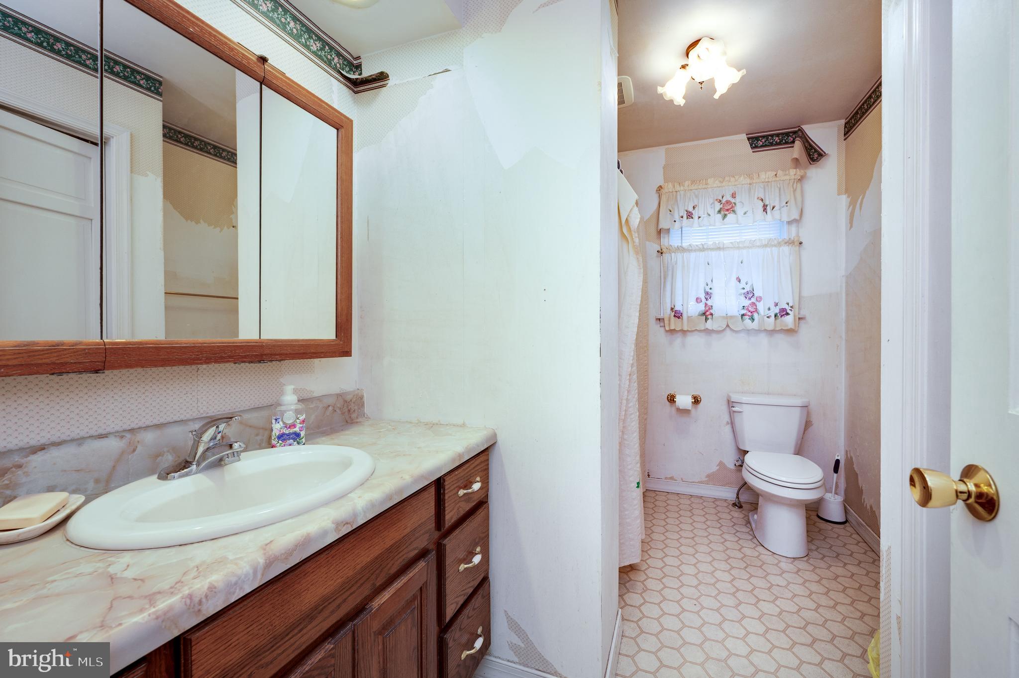 730 Texter Mountain Road Robesonia, PA 19551 - Photo 31 of 58 a bathroom with a granite countertop sink a toilet and a mirror