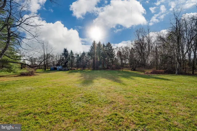 a view of a house with a backyard and a patio