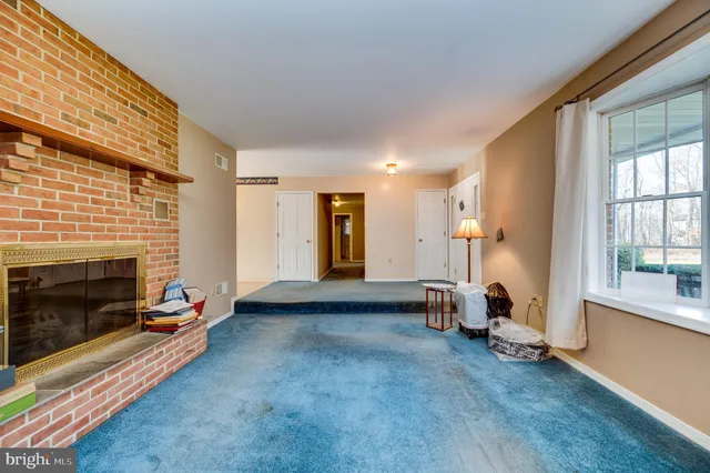 a view of a livingroom with furniture and a fireplace