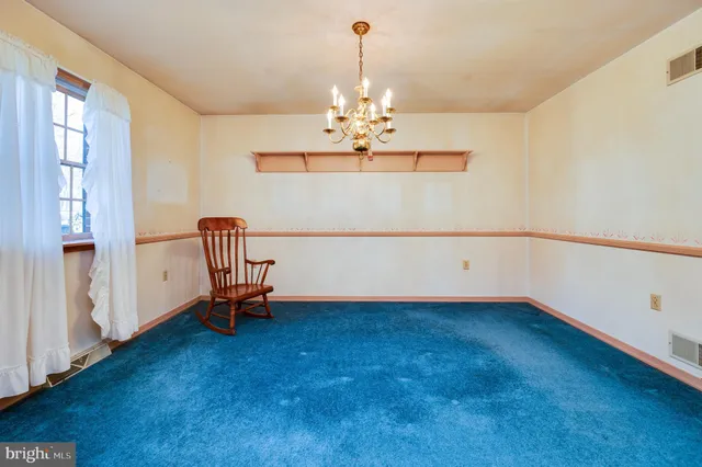 a view of a room with window ceiling fan and wooden floor