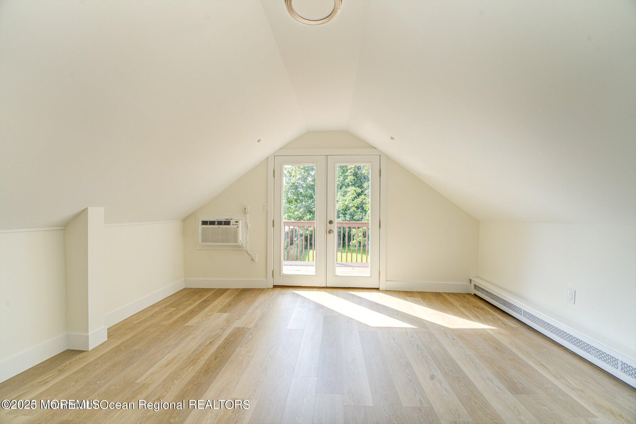 54 Main Street, Unit 2 Keyport, NJ 07735 - Photo 11 of 25 an empty room with wooden floor and windows