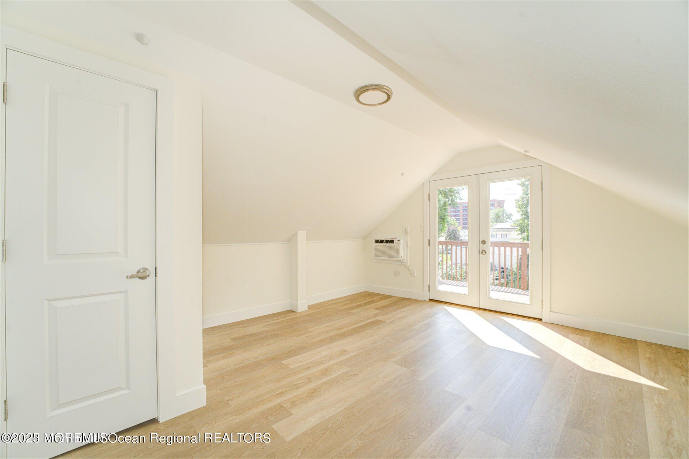 54 Main Street, Unit 2 Keyport, NJ 07735 - Photo 12 of 25 an empty room with wooden floor and windows