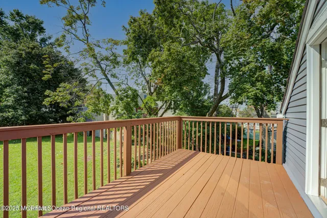 a view of balcony with wooden floor and fence