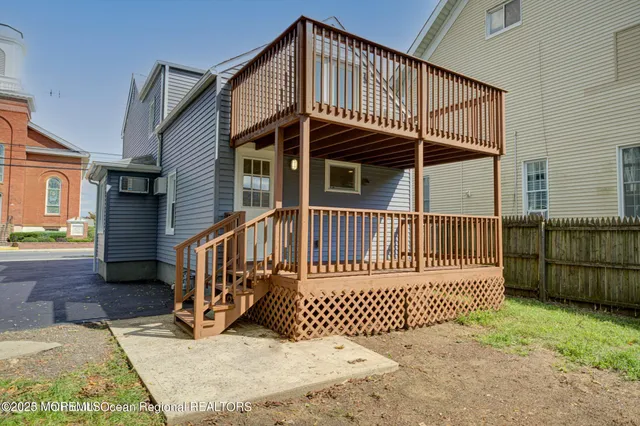 a view of a house with a wooden deck