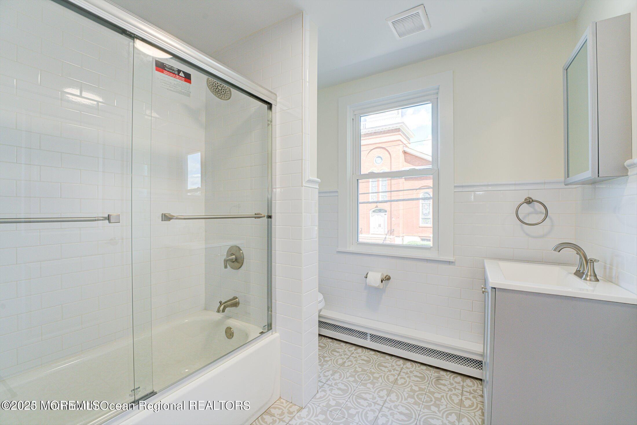 54 Main Street, Unit 2 Keyport, NJ 07735 - Photo 6 of 25 a bathroom with a bathtub and a sink
