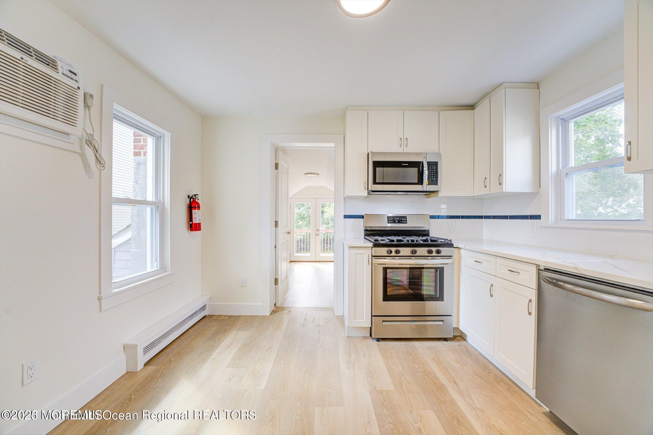 54 Main Street, Unit 2 Keyport, NJ 07735 - Photo 9 of 25 a kitchen with granite countertop a stove top oven and sink