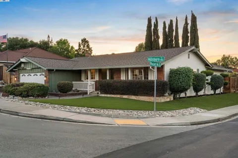 a view of a house next to a yard