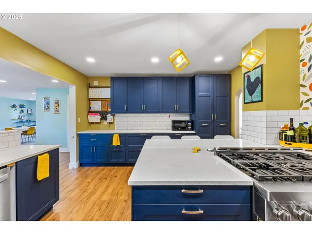 a kitchen with wooden cabinets and wooden floor