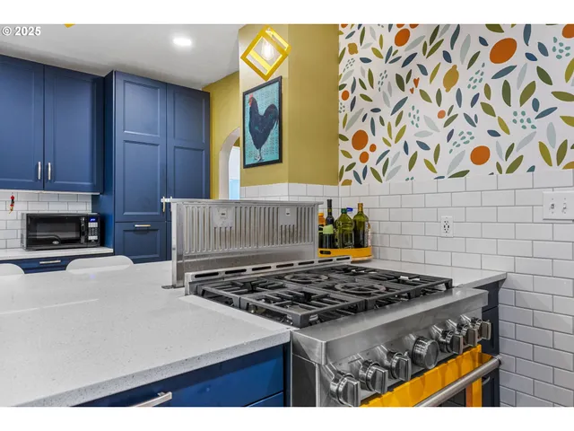 a kitchen with a stove and a white refrigerator