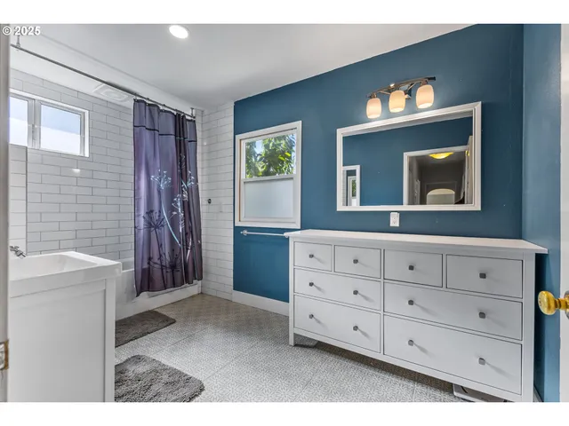 a bathroom with a sink a mirror and a vanity