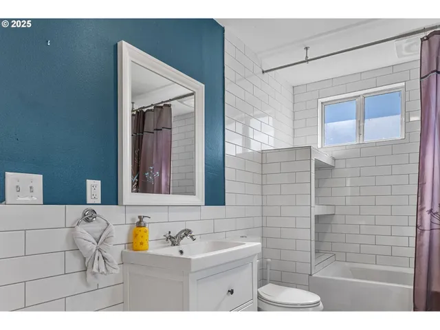 a bathroom with a sink a mirror and shower