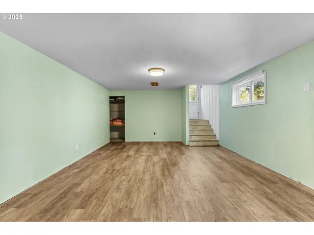 a view of an empty room and wooden floor