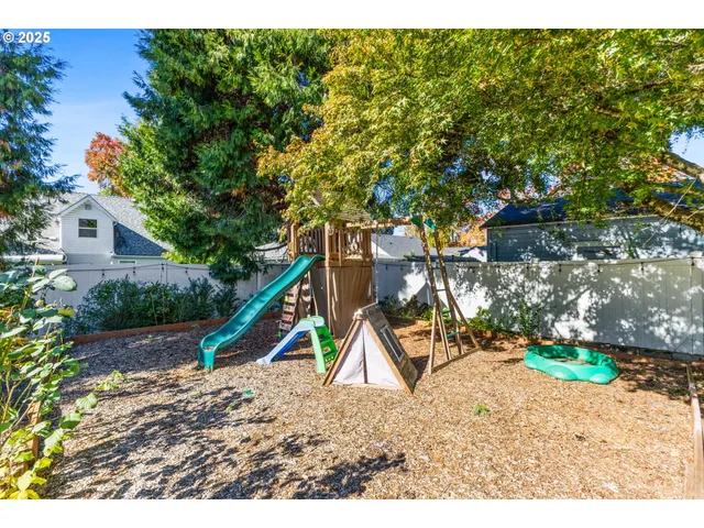 a backyard of a house with table and chairs