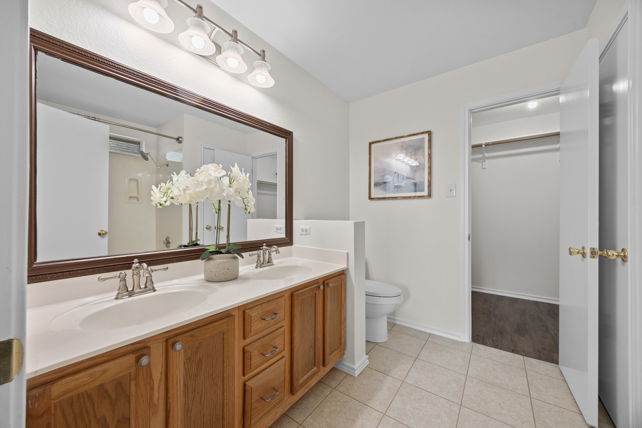 8219 Edgemoor Place Austin, TX 78749 - Photo 22 of 30 Primary en-suite bathroom with a tub/shower combo, freshly updated lighting, paint and refinished tub/tile cleaning.