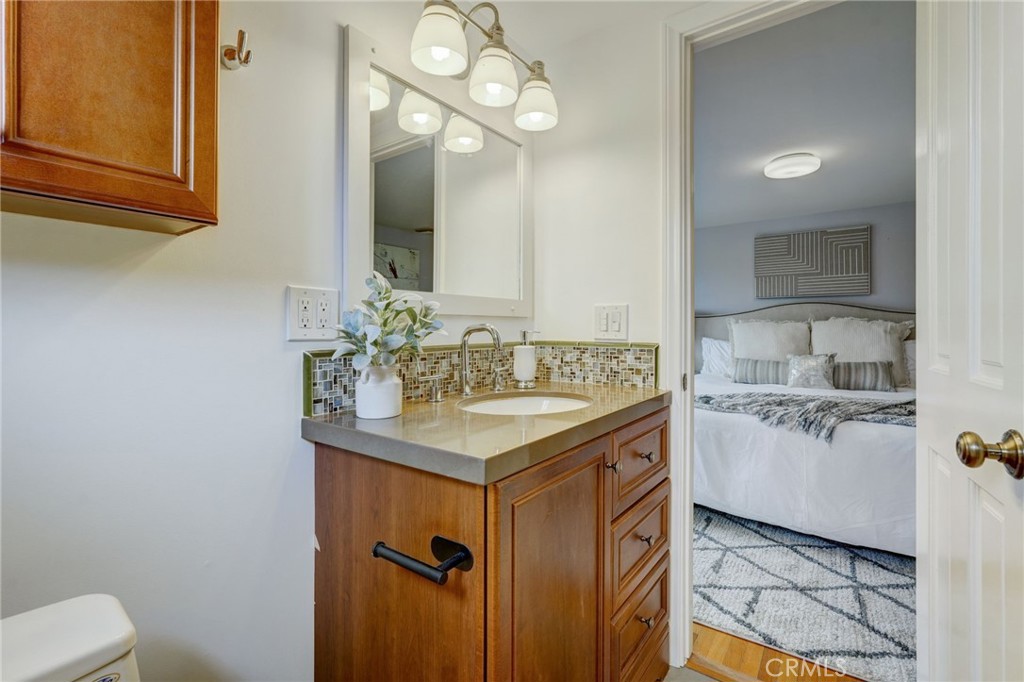 319 Longden Drive San Gabriel, CA 91775 - Photo 25 of 39 a bathroom with a granite countertop sink a toilet and mirror