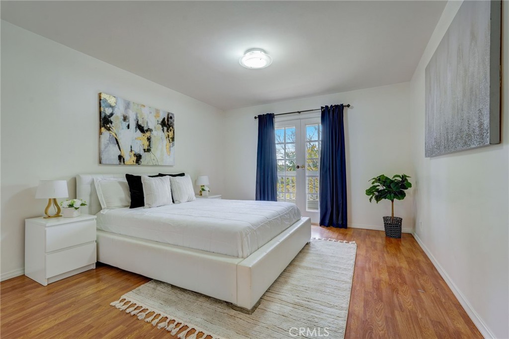 319 Longden Drive San Gabriel, CA 91775 - Photo 26 of 39 a bedroom with a large bed and a potted plant