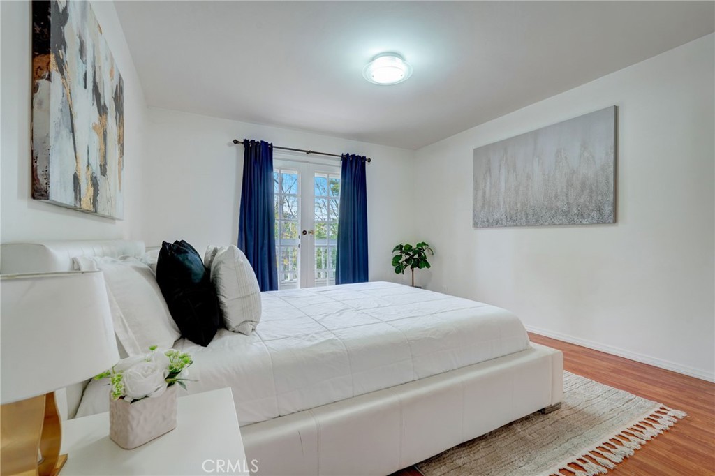 319 Longden Drive San Gabriel, CA 91775 - Photo 27 of 39 a bedroom with a bed lamp and a potted plant