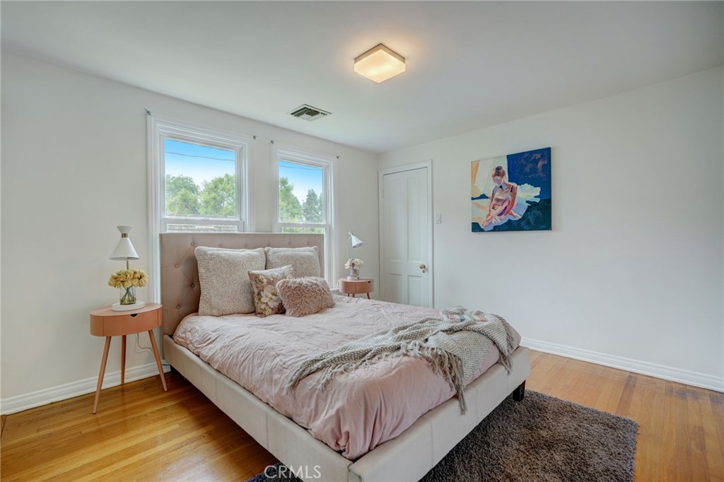 319 Longden Drive San Gabriel, CA 91775 - Photo 28 of 39 a bedroom with a bed and a painting on the wall