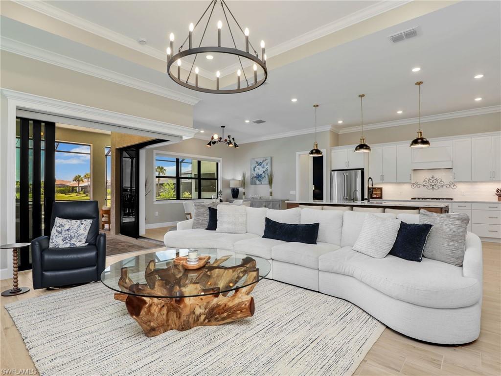 18412 Ridgeline Drive Estero, FL 33928 - Photo 12 of 50 a living room with furniture and a chandelier