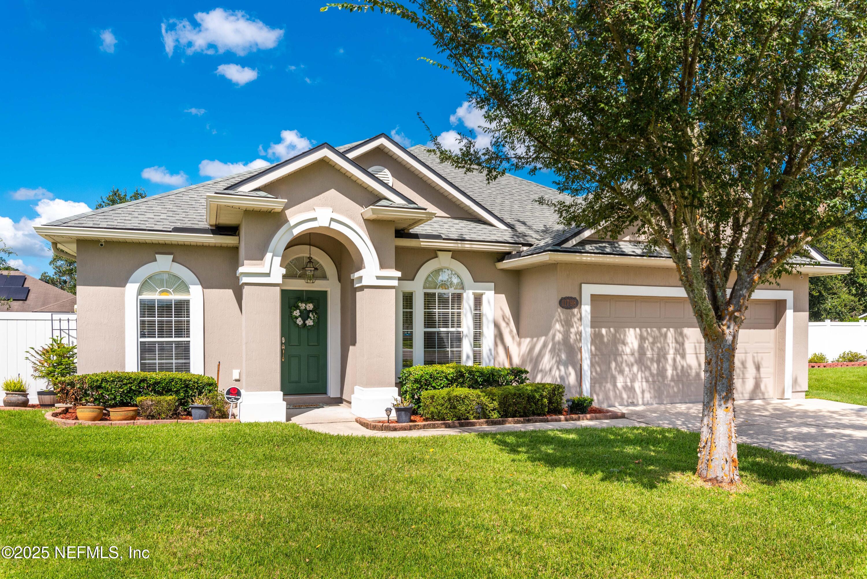 a front view of a house with a garden and plants