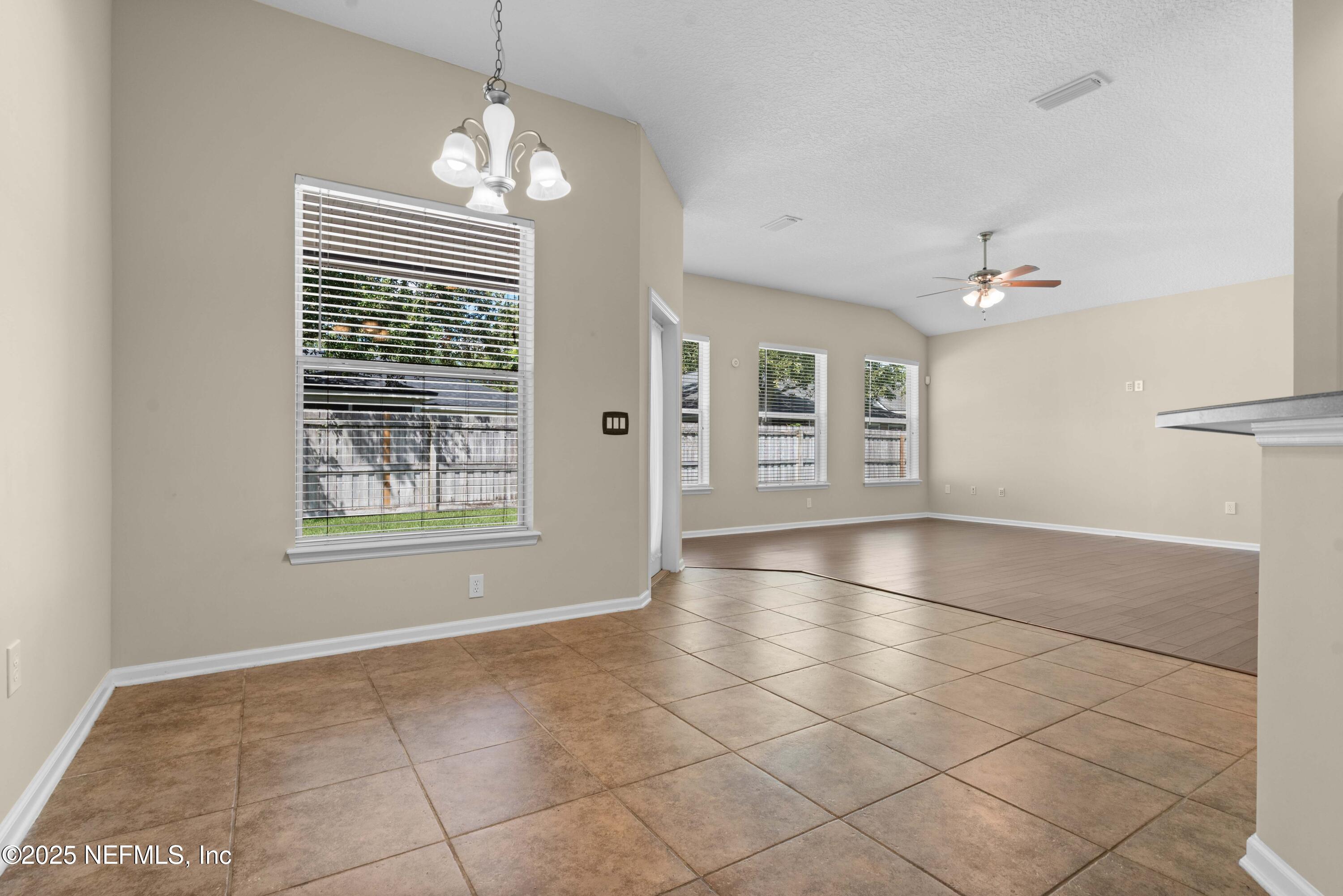 11798 Blueberry Lane Macclenny, FL 32063 - Photo 11 of 30 an empty room with windows and ceiling fan