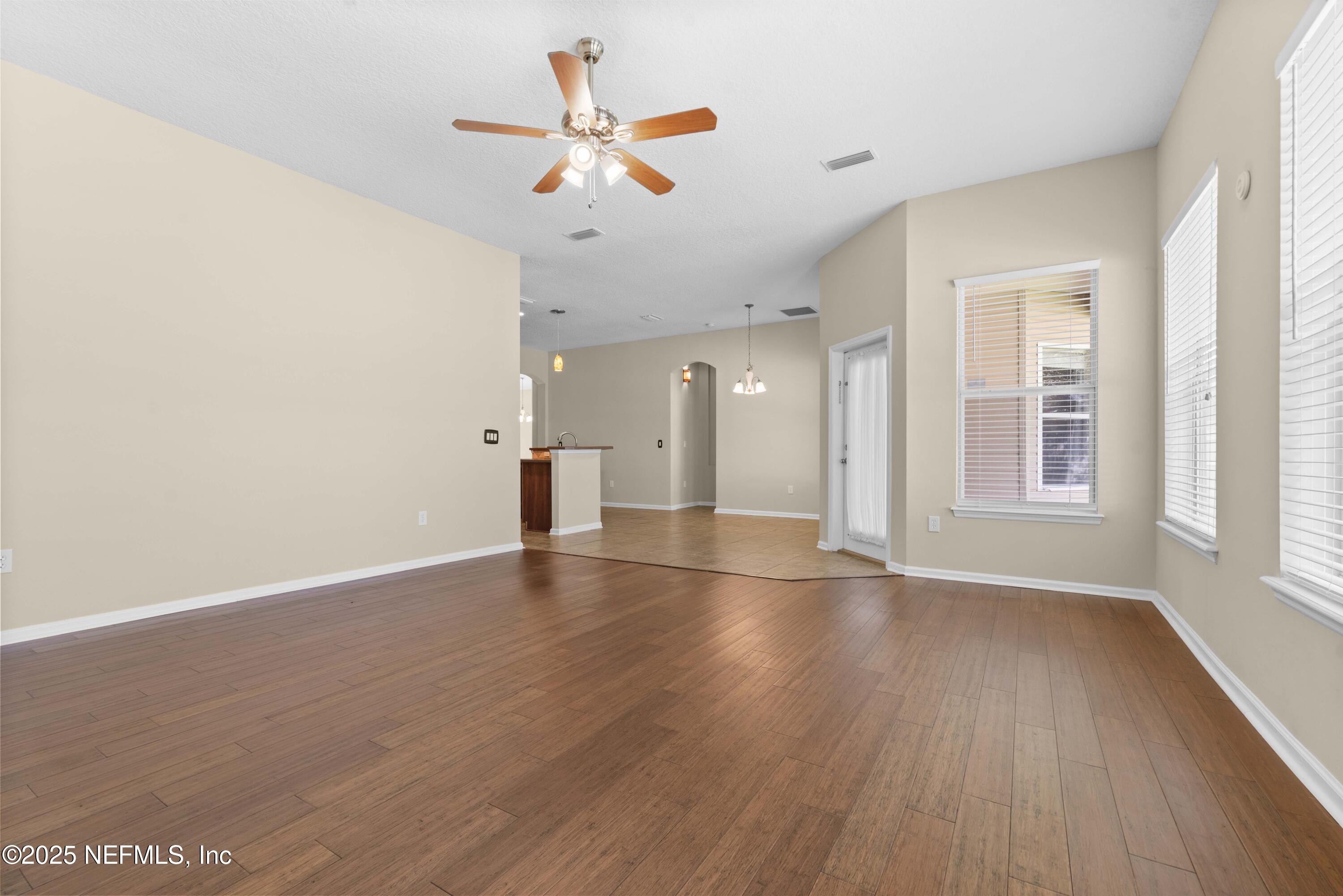 11798 Blueberry Lane Macclenny, FL 32063 - Photo 12 of 30 an empty room with wooden floor and windows