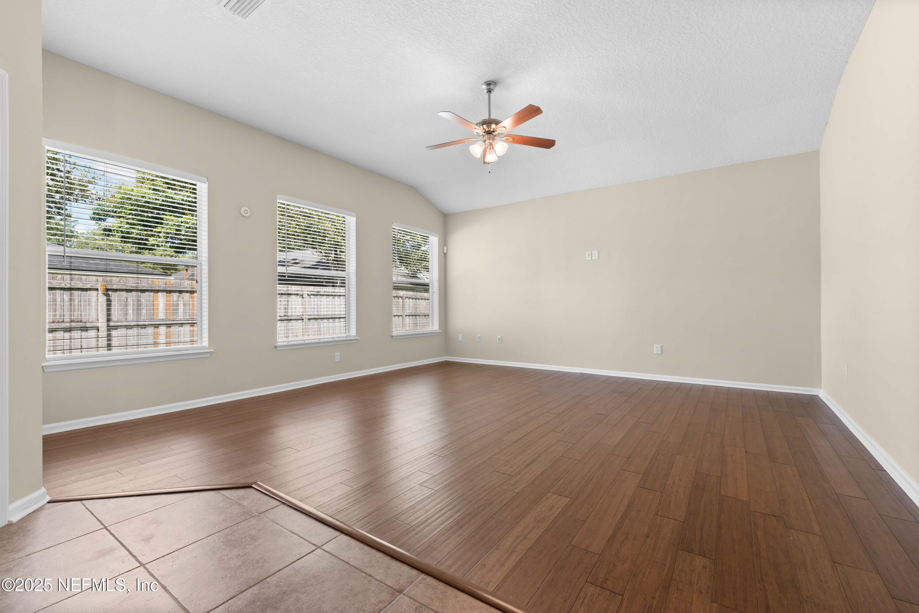 11798 Blueberry Lane Macclenny, FL 32063 - Photo 13 of 30 an empty room with wooden floor and windows