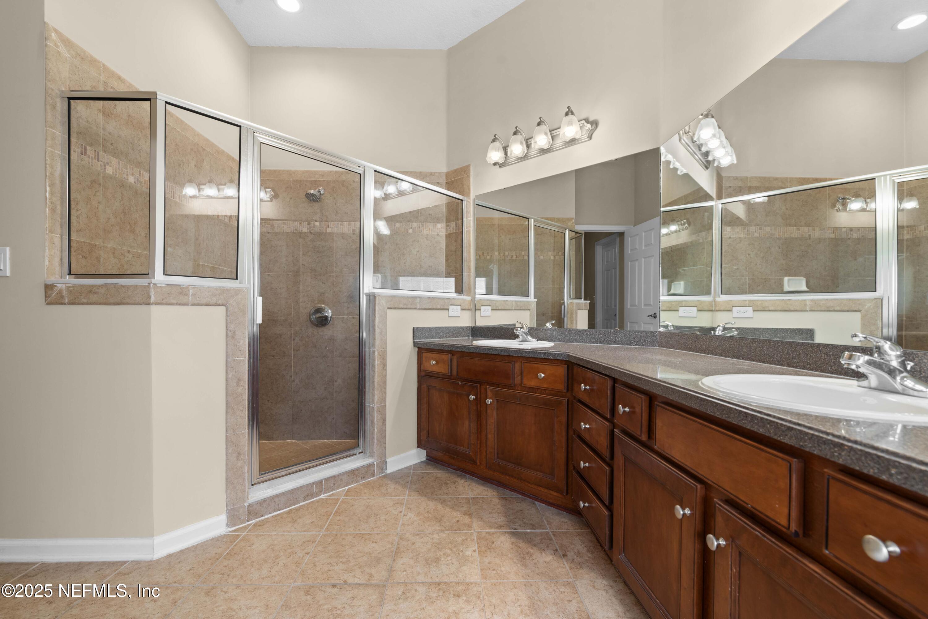 11798 Blueberry Lane Macclenny, FL 32063 - Photo 16 of 30 a spacious bathroom with a double vanity sink mirror and shower