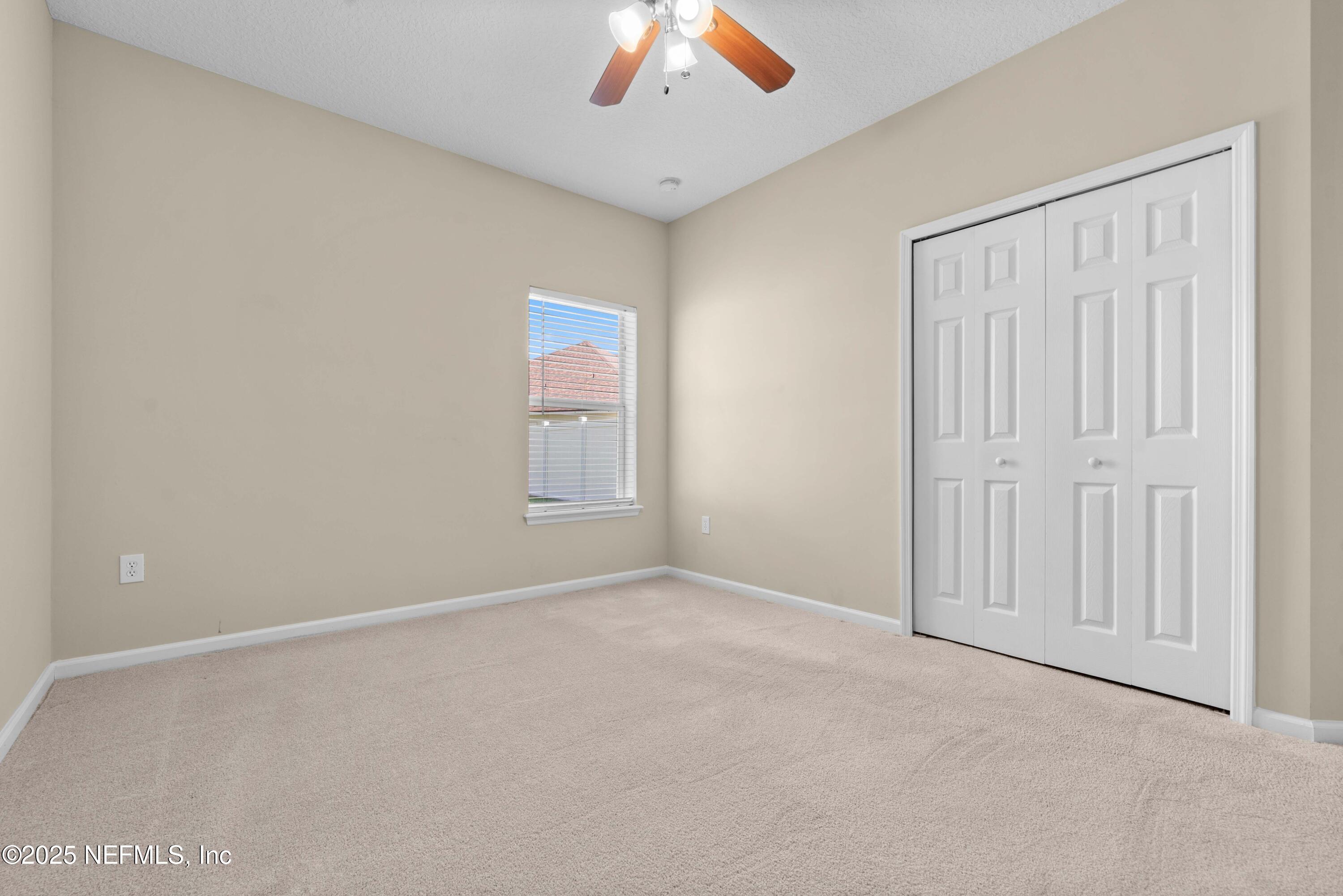 11798 Blueberry Lane Macclenny, FL 32063 - Photo 18 of 30 an empty room with a chandelier fan