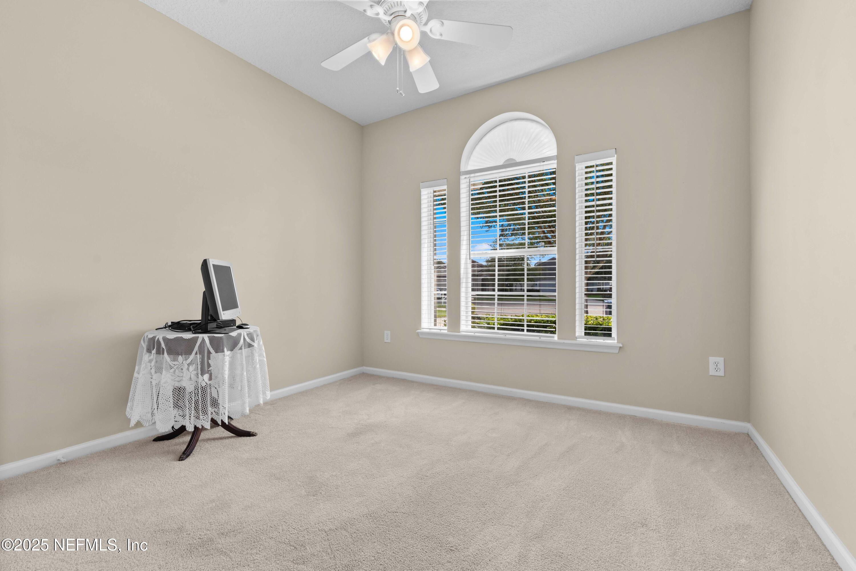 11798 Blueberry Lane Macclenny, FL 32063 - Photo 21 of 30 an empty room with chandelier fan and windows