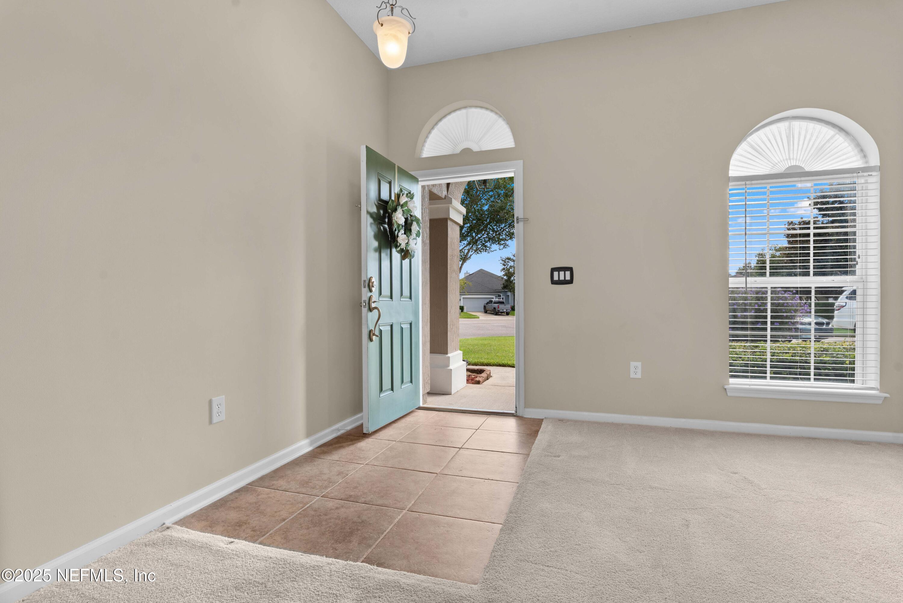 11798 Blueberry Lane Macclenny, FL 32063 - Photo 5 of 30 an empty room with windows and outdoor view