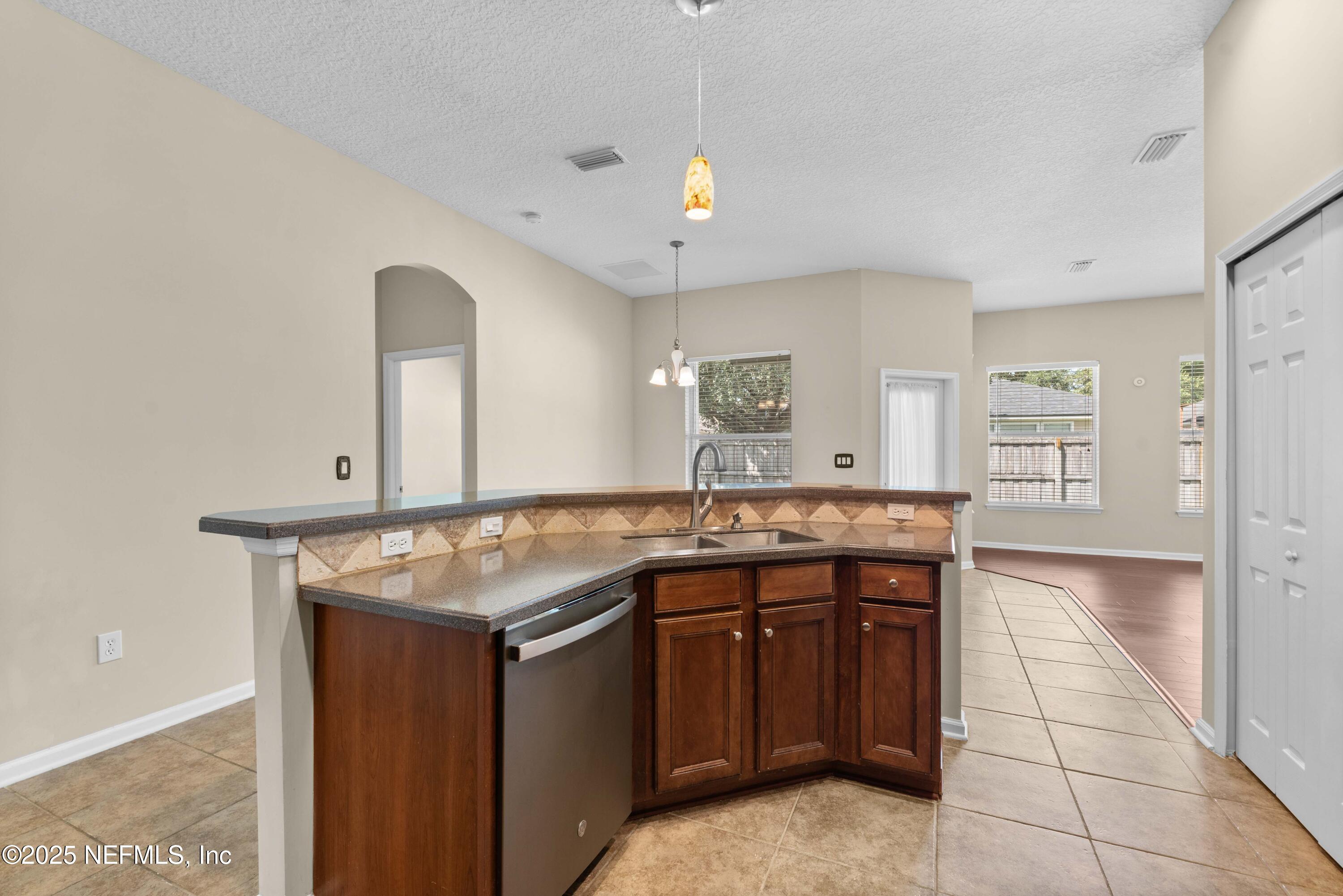 11798 Blueberry Lane Macclenny, FL 32063 - Photo 10 of 30 a kitchen with a sink and a refrigerator