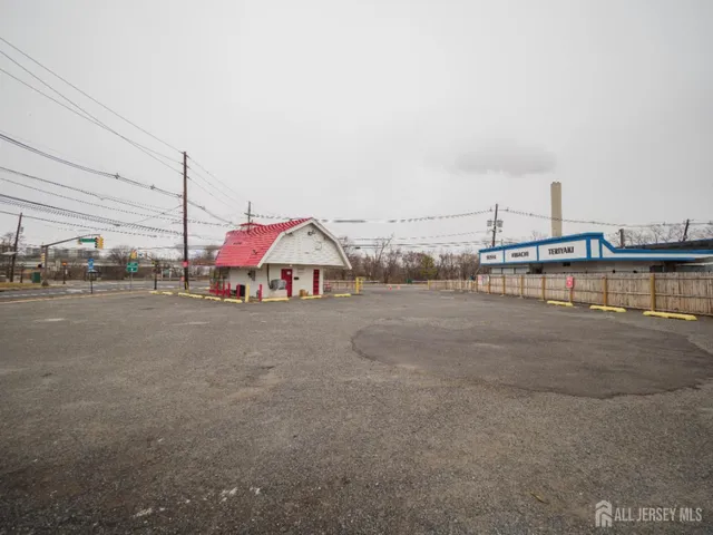 a backyard of a house with barbeque oven table and chairs
