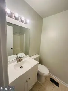a bathroom with a sink a toilet and mirror