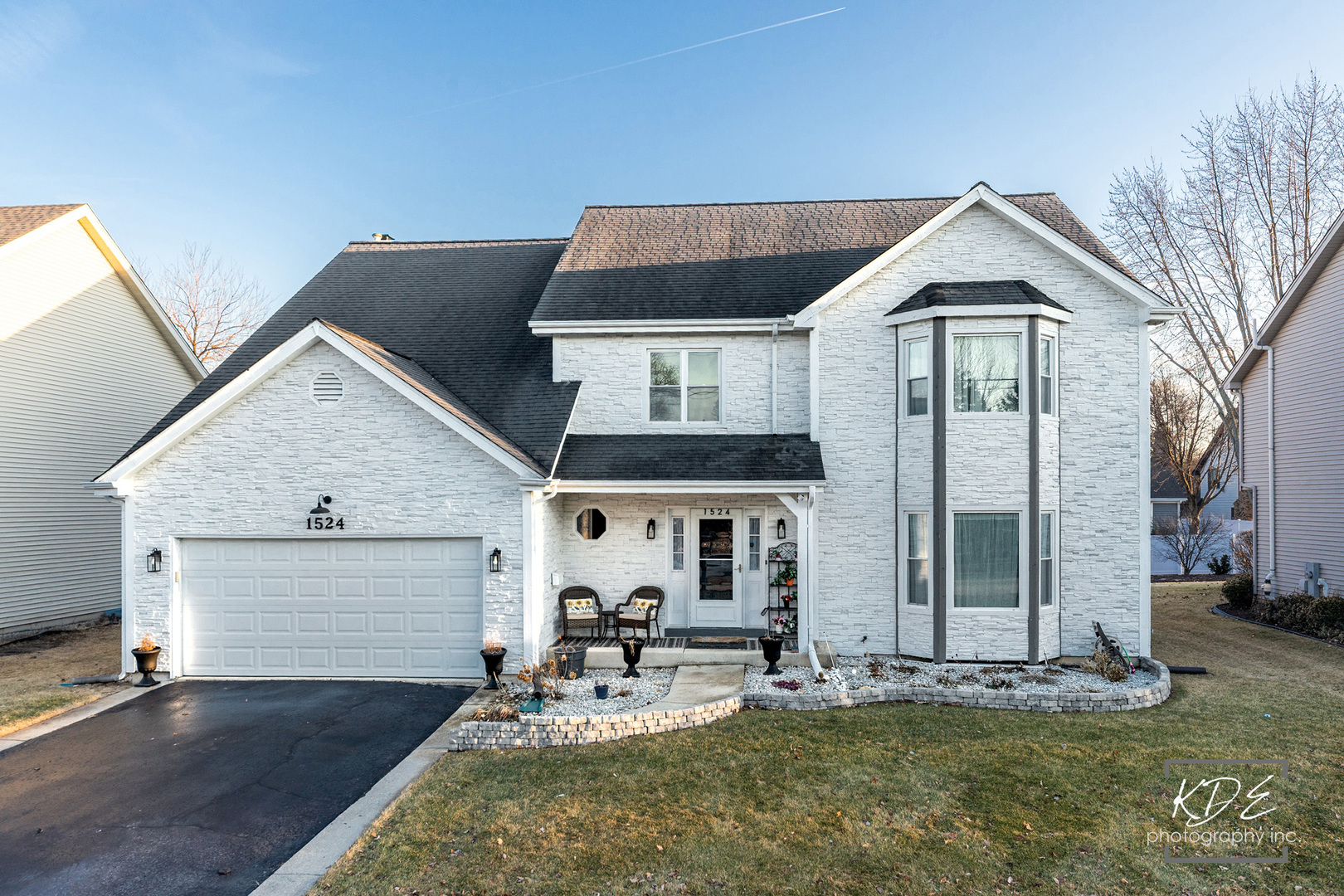 1524 Oswego Road Naperville, IL 60540 - Photo 2 of 40 a front view of a house with garden