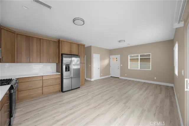 a kitchen with a refrigerator and a sink