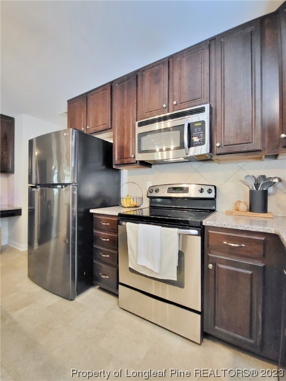 30 Bicentennial Way Cameron, NC 28326 - Photo 13 of 42 a kitchen with stainless steel appliances granite countertop a stove a refrigerator and a microwave