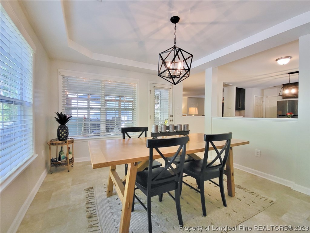 30 Bicentennial Way Cameron, NC 28326 - Photo 17 of 42 a view of a dining room and livingroom with furniture wooden floor a chandelier