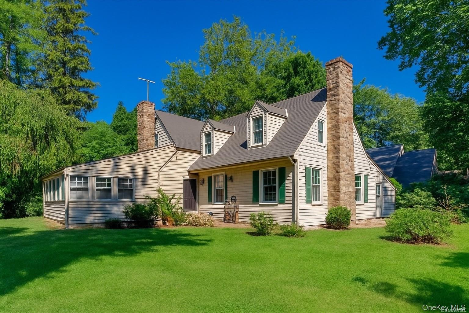 16 Ascot Ridge Great Neck, NY 11021 - Photo 1 of 23 Rear view of property with a chimney and a lawn