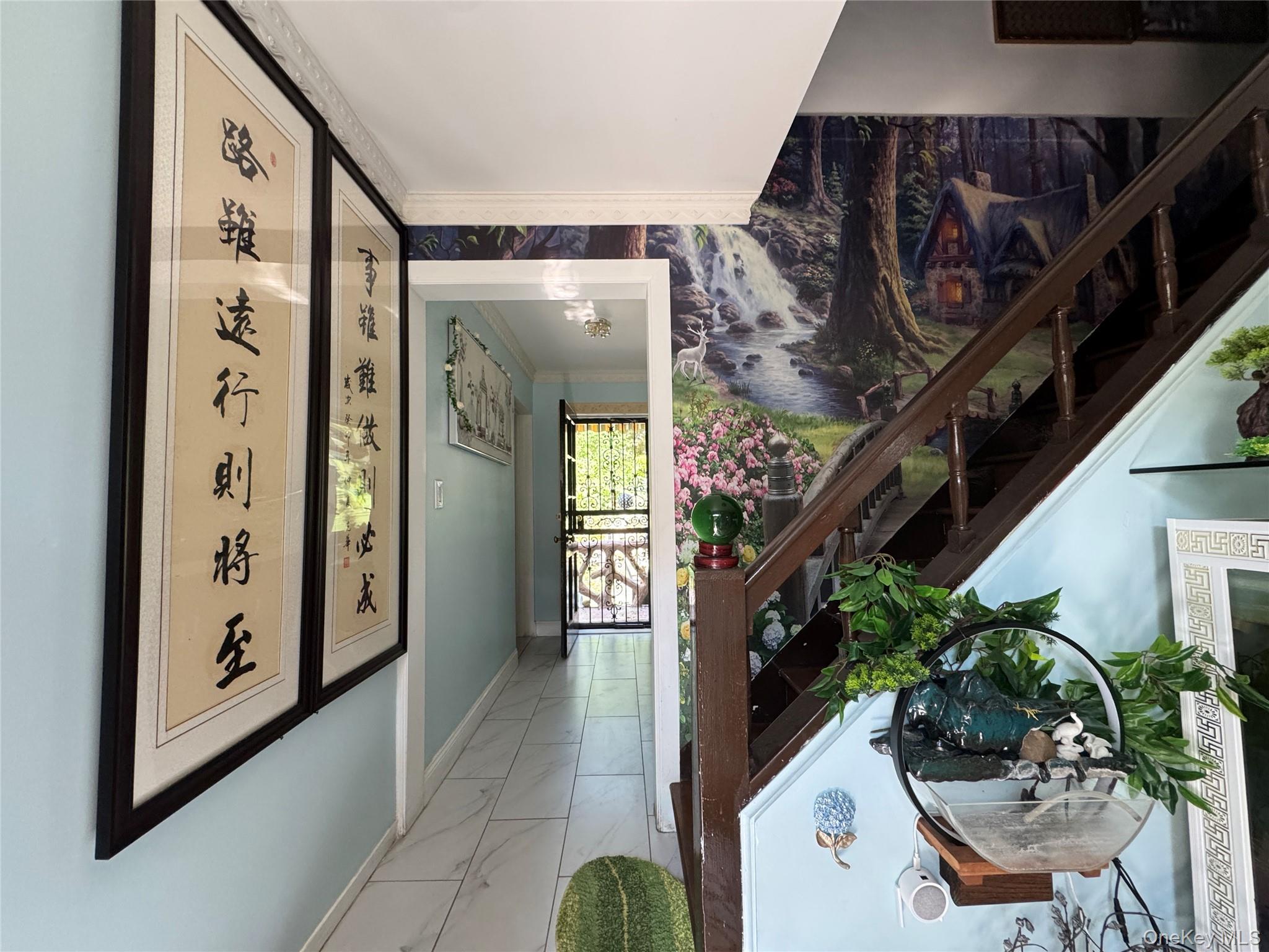 16 Ascot Ridge Great Neck, NY 11021 - Photo 11 of 23 Hallway featuring light marble finish floors, stairs, and ornamental molding