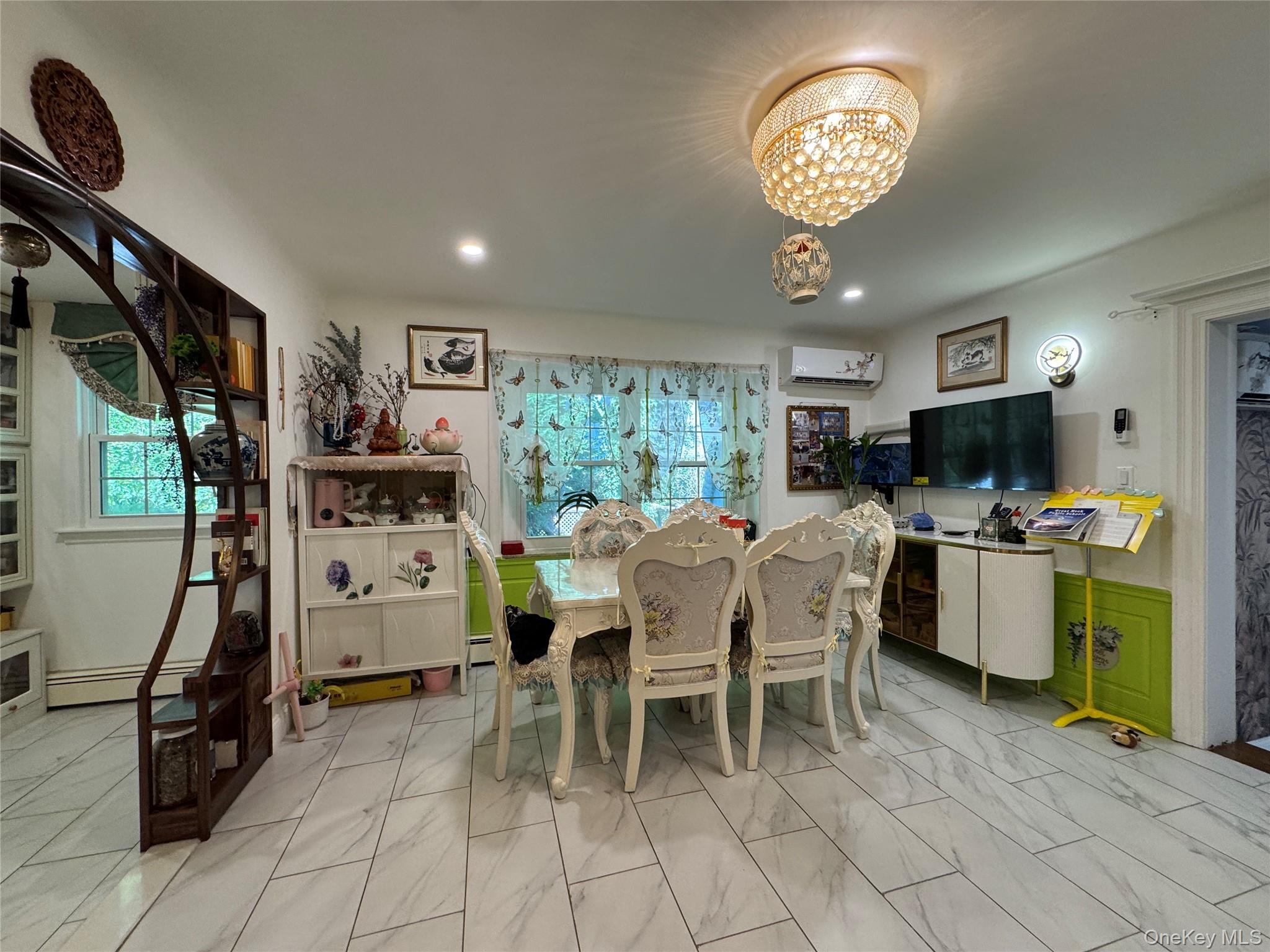 16 Ascot Ridge Great Neck, NY 11021 - Photo 13 of 23 Dining room with a baseboard radiator, light marble finish flooring, a chandelier, and plenty of natural light