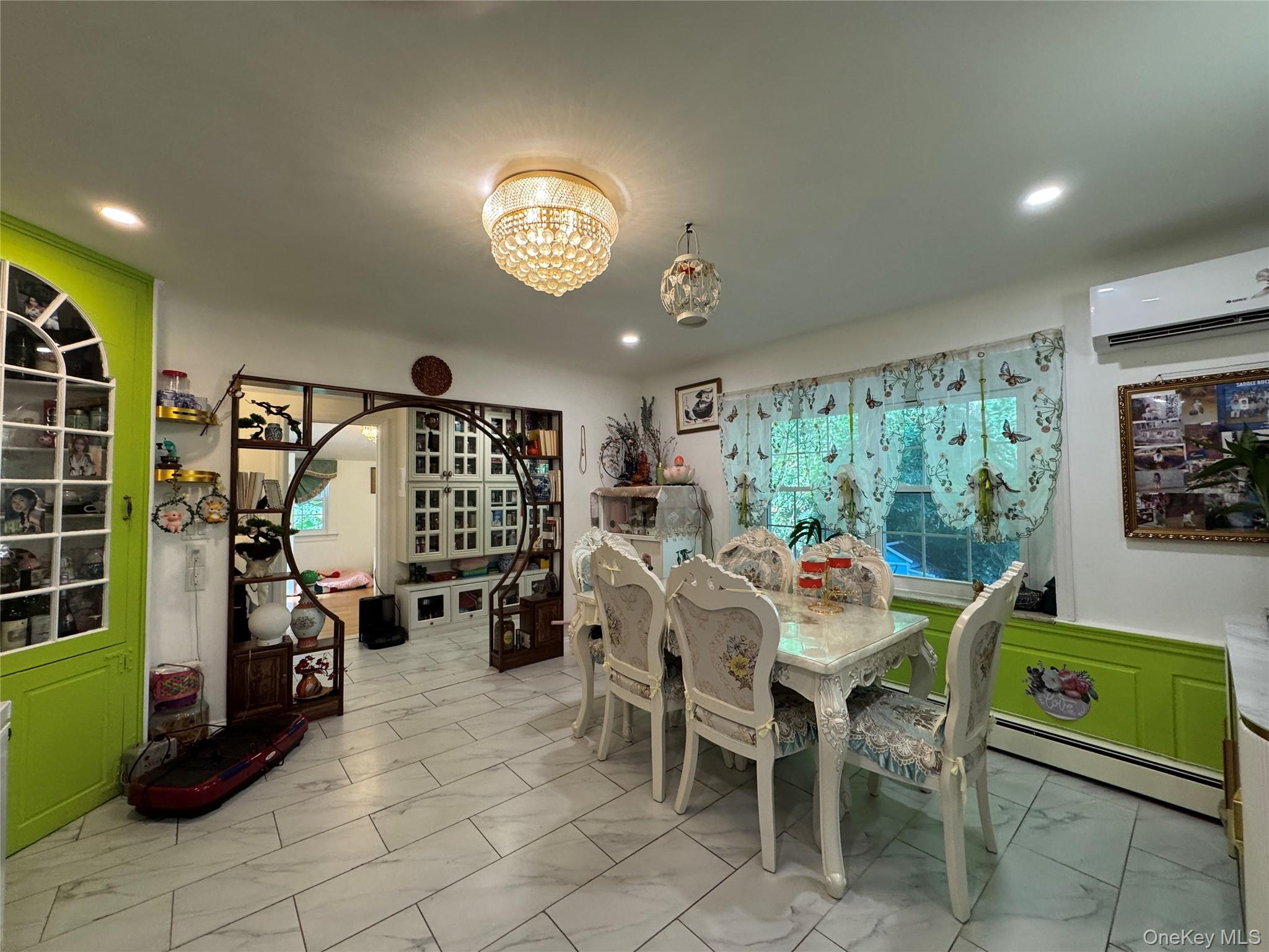 16 Ascot Ridge Great Neck, NY 11021 - Photo 14 of 23 Dining room featuring a wall mounted AC, a chandelier, light marble finish flooring, and recessed lighting