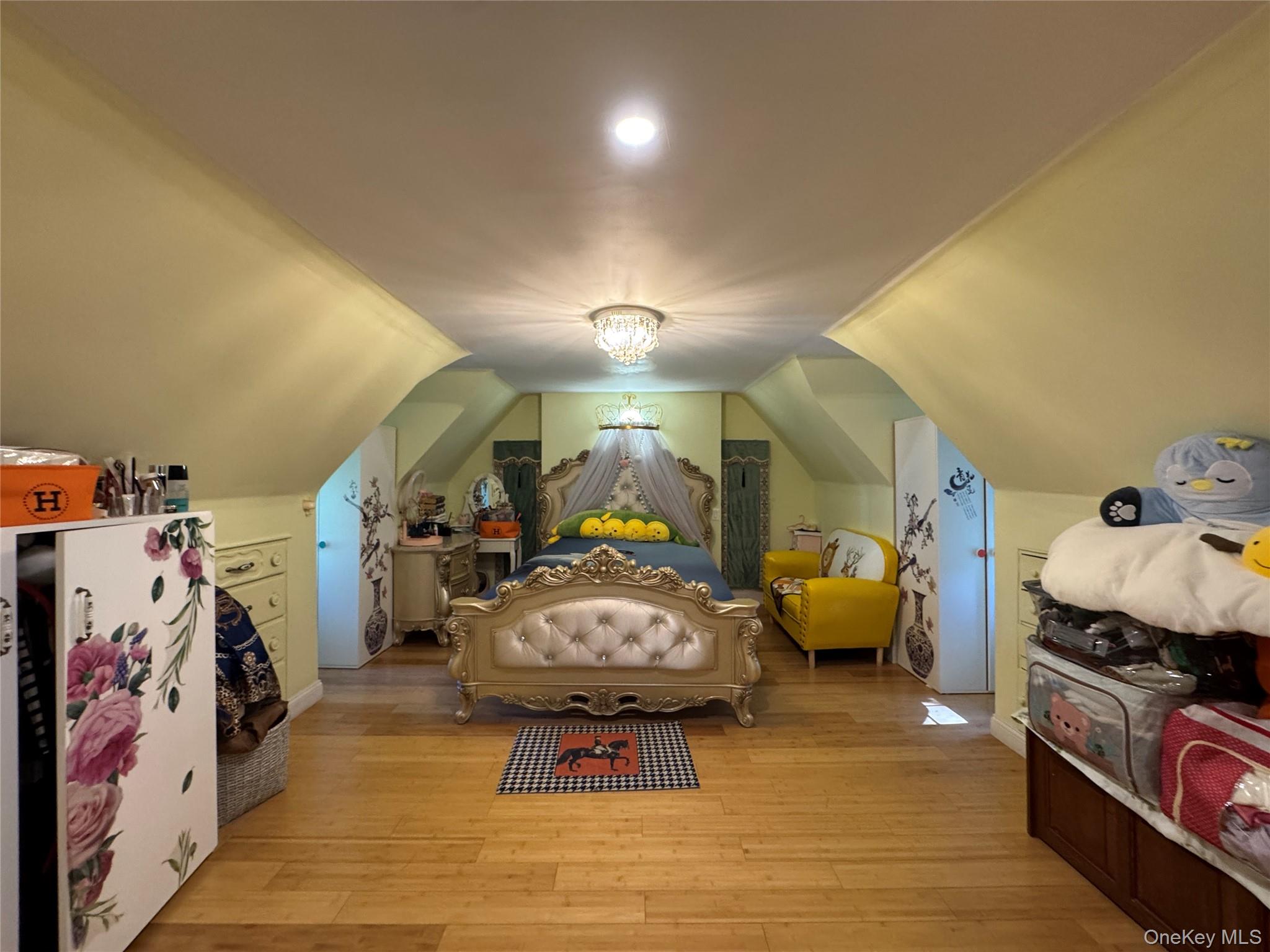 16 Ascot Ridge Great Neck, NY 11021 - Photo 15 of 23 Bedroom featuring light wood-type flooring and vaulted ceiling