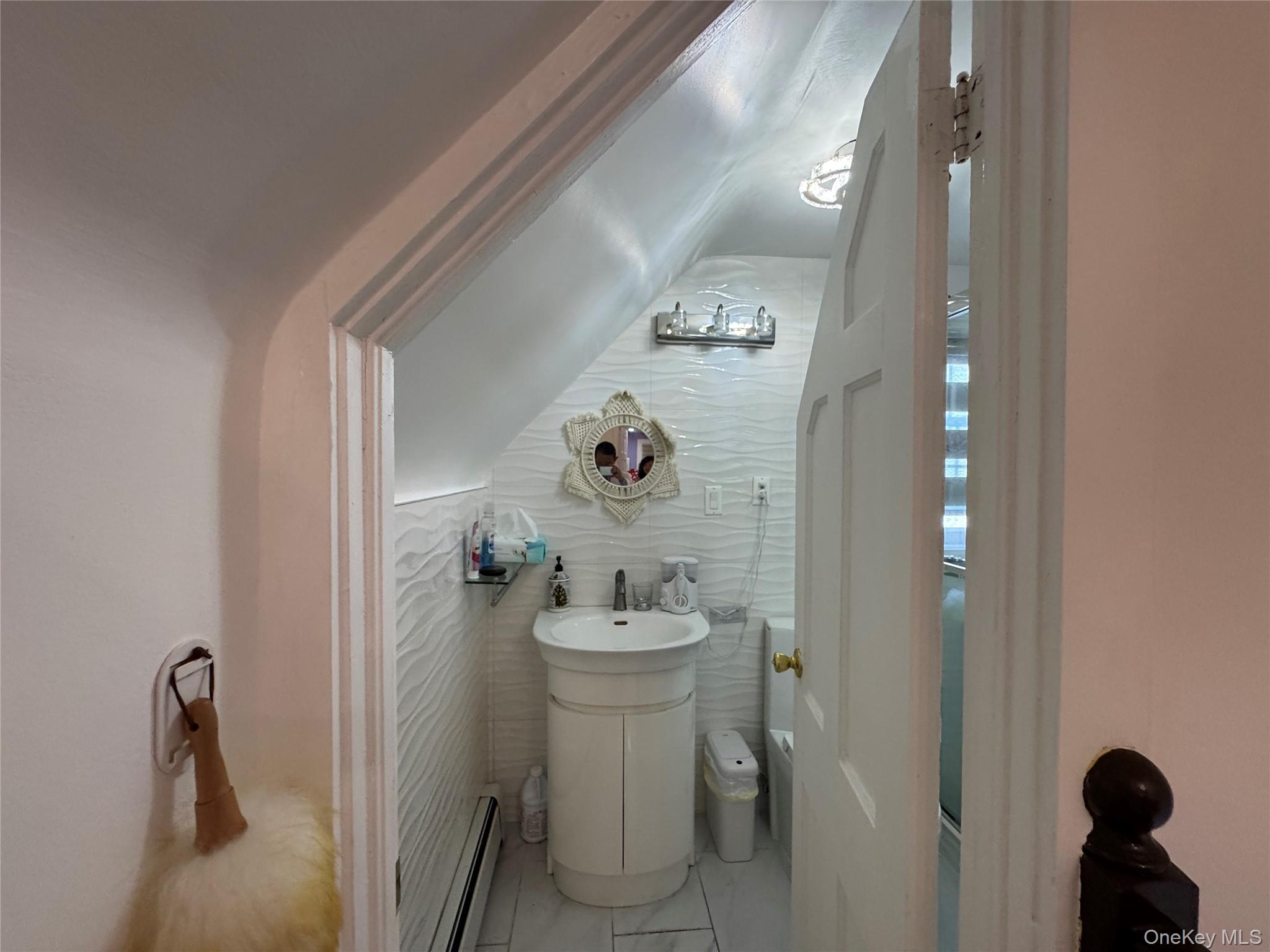 16 Ascot Ridge Great Neck, NY 11021 - Photo 23 of 23 Bathroom featuring baseboard heating, tile walls, and light marble finish flooring